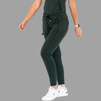Full front view of women's scrub joggers 920 super stretch bottle green with model walking.