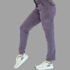 Women's light purple Style 930 scrub pants, side view with leg slightly bent showing side pocket.