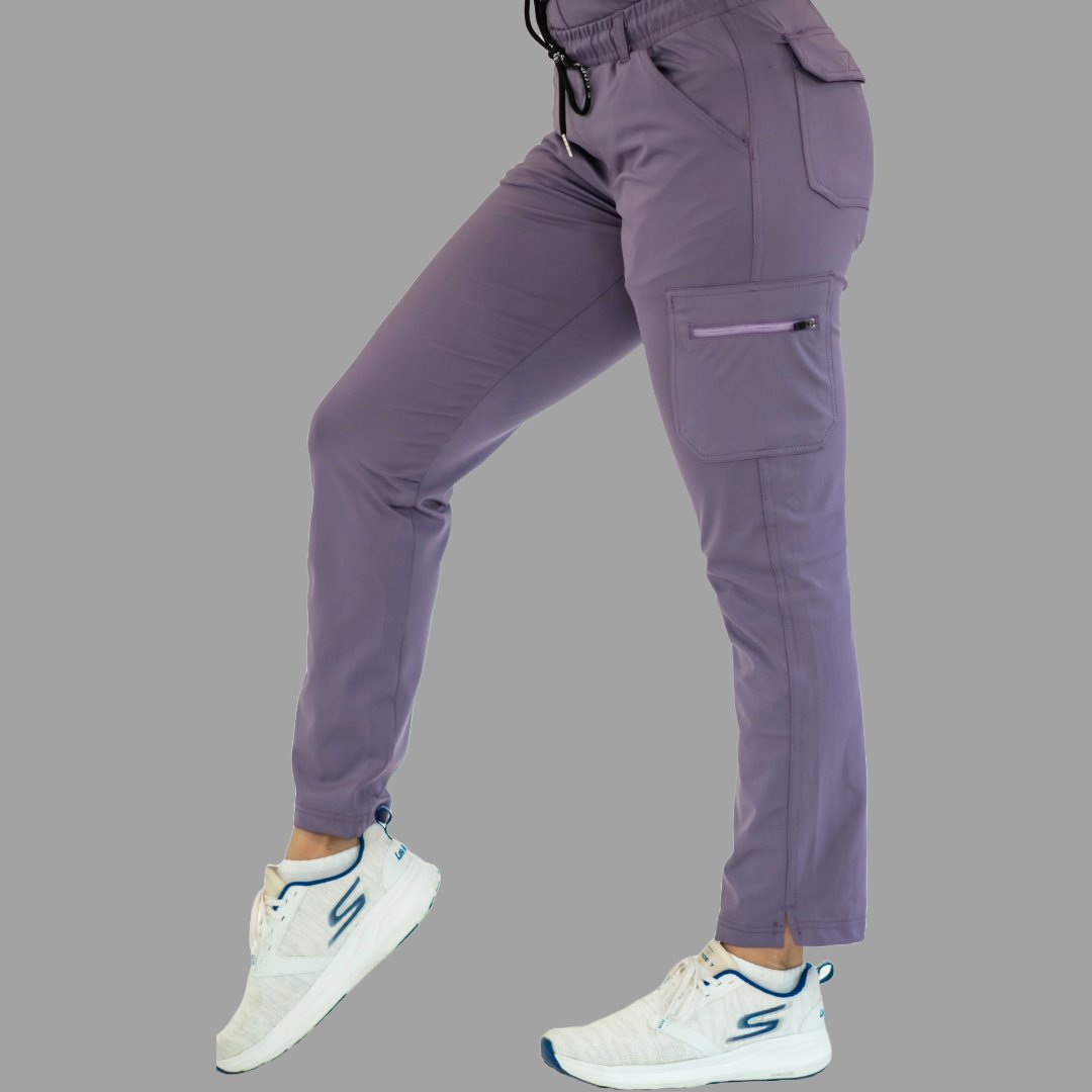Women's light purple Style 930 scrub pants, side view with leg slightly bent showing side pocket.