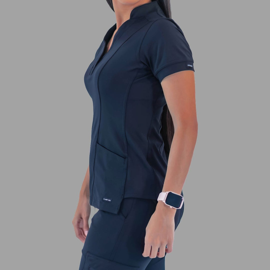 Side view of a woman wearing the navy blue Style 930 scrub top, showing the garment's fit and sleeve length.