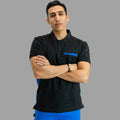Men’s Black / Royal Blue 930 scrub top with arms crossed, showing chest accent and slim fit.